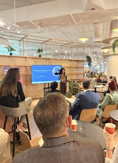 An Expert Ease practitioner presenting to a seated audience